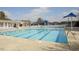 Large outdoor swimming pool with lounge chairs and shaded seating areas for community enjoyment at 112 Fairford Dr, Holly Springs, NC 27540