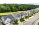 Aerial view of a neighborhood lined with sidewalks and beautiful landscaping, near lush woodland at 113 Mazarin Ln, Cary, NC 27519