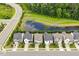 Beautiful homes with well-maintained yards next to pond and green space in a suburban neighborhood at 113 Mazarin Ln, Cary, NC 27519