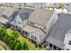 Aerial view of townhomes with gray roofs, manicured lawns and mature landscaping at 113 Mazarin Ln, Cary, NC 27519
