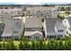 Aerial view of townhomes with gray roofs, manicured lawns and mature landscaping at 113 Mazarin Ln, Cary, NC 27519