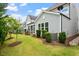 Serene backyard with a green lawn, mature landscaping, and private screened porches at 113 Mazarin Ln, Cary, NC 27519
