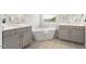 Beautiful bathroom featuring double vanities, a freestanding tub, and eye-catching patterned tile floors at 113 Mazarin Ln, Cary, NC 27519