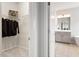 Bathroom and closet visible from hallway, featuring vanity and patterned floor tiles at 113 Mazarin Ln, Cary, NC 27519