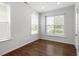 Bright bedroom with hardwood floors, large windows, and white walls throughout the room at 113 Mazarin Ln, Cary, NC 27519