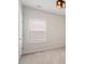 Bedroom featuring plush carpet, a single window, and a sleek, modern ceiling light fixture at 113 Mazarin Ln, Cary, NC 27519