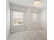 Bedroom with plush carpet and two windows for natural light, complimented by a stylish chandelier at 113 Mazarin Ln, Cary, NC 27519