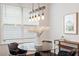 Bright dining area with wood floors, a glass table and modern lighting at 113 Mazarin Ln, Cary, NC 27519