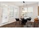 Bright dining area with wood floors, modern lighting, and large windows at 113 Mazarin Ln, Cary, NC 27519
