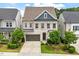 Charming two-story home with light brick, a two-car garage and a well-manicured lawn at 113 Mazarin Ln, Cary, NC 27519