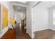 Inviting entryway with wood floors, staircase, and decorative accents leading to a bright room at 113 Mazarin Ln, Cary, NC 27519