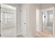 Upstairs hallway with two open doors showcasing the neutral color palette and carpeted floor at 113 Mazarin Ln, Cary, NC 27519