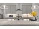 Stylish kitchen featuring a gray center island with granite countertops, stainless steel appliances, and a hood vent at 113 Mazarin Ln, Cary, NC 27519