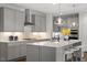 Stylish kitchen featuring a gray center island with granite countertops, stainless steel appliances, and seating at 113 Mazarin Ln, Cary, NC 27519