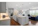 Modern kitchen featuring a gray center island, granite countertops and stainless steel appliances at 113 Mazarin Ln, Cary, NC 27519