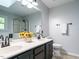 Bright bathroom featuring a double sink, large mirror, and walk-in shower with glass door at 114 Oxpens Rd, Cary, NC 27513