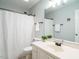 Clean bathroom with a shower-tub combo, white vanity, and neutral flooring at 114 Oxpens Rd, Cary, NC 27513