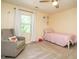 Bright bedroom with large window, soft chair, and a comfortable single bed with a pink quilt at 114 Oxpens Rd, Cary, NC 27513