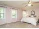 Bright bedroom with a ceiling fan, two windows with beautiful natural light, and a decorative headboard at 114 Oxpens Rd, Cary, NC 27513