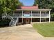 Exterior view of clubhouse with sign and stairs leading up to the entrance and wraparound porch at 114 Oxpens Rd, Cary, NC 27513