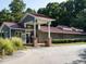 Exterior view of clubhouse showing the facade, parking and lush landscape at 114 Oxpens Rd, Cary, NC 27513