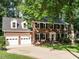 Attractive two-story brick home with two-car garage, mature trees, and well-manicured lawn at 114 Oxpens Rd, Cary, NC 27513