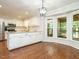 Bright kitchen with bay window overlooking screened deck, stainless appliances and wood floors at 114 Oxpens Rd, Cary, NC 27513
