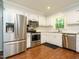 Modern kitchen with stainless steel appliances, white cabinets, and granite countertops at 114 Oxpens Rd, Cary, NC 27513