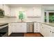 Bright kitchen featuring white cabinets, stainless steel appliances, and granite countertops at 114 Oxpens Rd, Cary, NC 27513