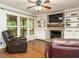 Inviting living room featuring a fireplace, built-in shelves, and a ceiling fan at 114 Oxpens Rd, Cary, NC 27513