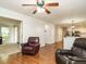 Inviting living room with wood floors, ceiling fan, and view of the kitchen at 114 Oxpens Rd, Cary, NC 27513