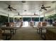 Interior view of picnic pavilion with several picnic tables and ceiling fans with a view of the pool at 114 Oxpens Rd, Cary, NC 27513