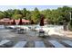 Exterior of pool with lounge chairs and tables shaded by umbrellas at 114 Oxpens Rd, Cary, NC 27513
