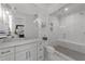 Bright bathroom featuring a glass shower and a white vanity with marble countertop at 1208 Hunting Ridge Rd, Raleigh, NC 27615