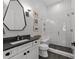 Modern bathroom features a glass-enclosed shower, sleek vanity with a dark countertop, and stylish fixtures at 1208 Hunting Ridge Rd, Raleigh, NC 27615