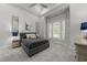 Well-lit bedroom with neutral tones, plush carpeting, and elegant window treatments at 1208 Hunting Ridge Rd, Raleigh, NC 27615