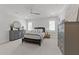 Relaxing bedroom featuring plantation shutters, soft carpet, and neutral gray furnishings at 1208 Hunting Ridge Rd, Raleigh, NC 27615
