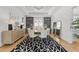Dining room with modern lighting, a geometric rug, and glass display cabinets at 1208 Hunting Ridge Rd, Raleigh, NC 27615