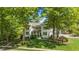 Charming two-story home with landscaped yard, beautiful lawn, and mature trees providing shade and curb appeal at 1208 Hunting Ridge Rd, Raleigh, NC 27615