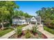 Aerial view of a white home with mature trees, a spacious front yard, and a three-car garage at 1208 Hunting Ridge Rd, Raleigh, NC 27615