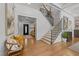 Elegant foyer with staircase, light hardwood floors, entry to other rooms, and stylish decor at 1208 Hunting Ridge Rd, Raleigh, NC 27615