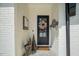 Charming front entrance with a black door, neutral decor, and a welcoming mat at 1208 Hunting Ridge Rd, Raleigh, NC 27615