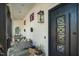 Charming covered porch featuring cozy seating, decorative accents, and a unique black door with ornate glass panels at 1208 Hunting Ridge Rd, Raleigh, NC 27615