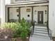 Inviting front porch with stone steps, stylish seating, and manicured landscaping leading to an ornate front door at 1208 Hunting Ridge Rd, Raleigh, NC 27615