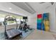 Home gym with a treadmill, stationary bike, and ample natural light from the windows at 1208 Hunting Ridge Rd, Raleigh, NC 27615