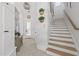 Stylish hallway featuring modern light fixtures, staircase, and unique decor at 1208 Hunting Ridge Rd, Raleigh, NC 27615