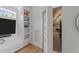 Bright home office featuring hardwood floors, natural light, custom shelving, and neutral colors at 1208 Hunting Ridge Rd, Raleigh, NC 27615