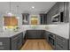 Beautiful kitchen with gray cabinetry, stone countertops, and stainless steel appliances at 1208 Hunting Ridge Rd, Raleigh, NC 27615