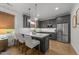 Modern kitchen featuring gray cabinets, stainless steel appliances, and a stylish island with seating at 1208 Hunting Ridge Rd, Raleigh, NC 27615