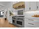 Close up of a modern kitchen with stainless steel range and hood at 1208 Hunting Ridge Rd, Raleigh, NC 27615